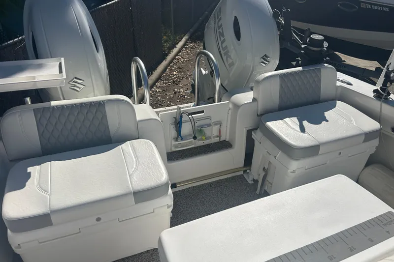 Slide: The Image of 2021 Twin Vee 260 VIVA boat interior with cushioned seating and dual Suzuki engines. - 14