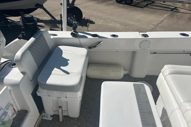 Slide: The Image of 2021 Twin Vee 260 VIVA boat interior with white seating and fishing rod holders. - 18