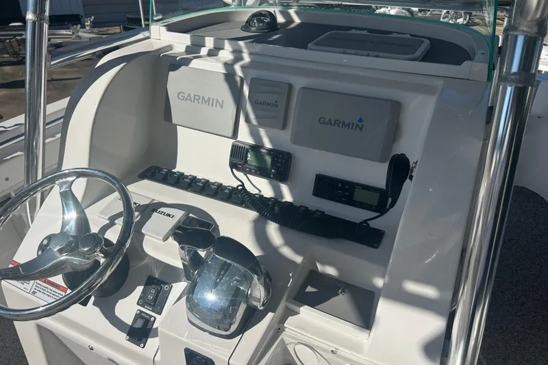 Slide: The Image of 2021 Twin Vee 260 VIVA boat dashboard with Garmin navigation and Suzuki controls. - 20