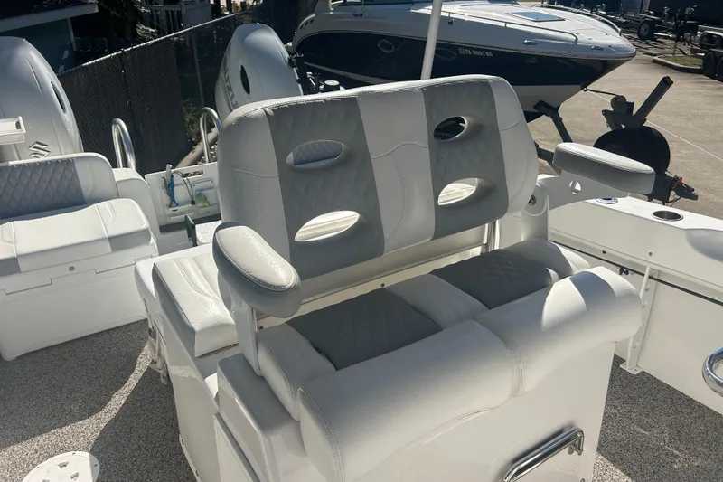 Slide: The Image of 2021 Twin Vee 260 VIVA boat interior with cushioned seating and armrests. - 21