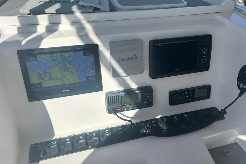 Slide: The Image of 2021 Twin Vee 260 VIVA boat dashboard with Garmin navigation and control systems. - 27