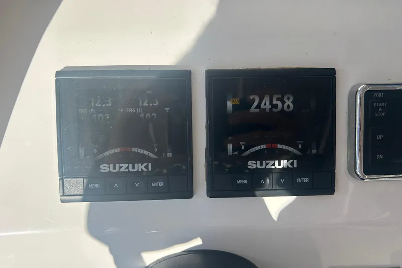 Slide: The Image of Twin Vee 260 VIVA 2021 boat dashboard with Suzuki engine displays. - 34