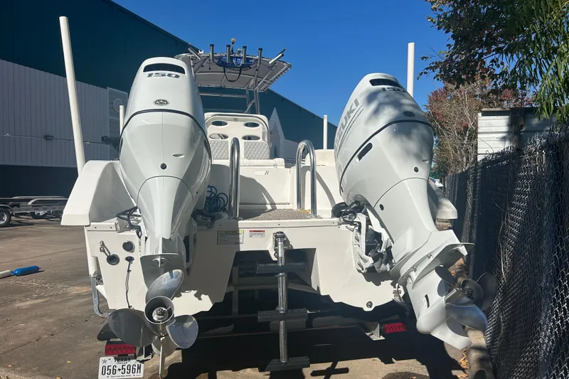 Slide: The Image of 2021 Twin Vee 260 VIVA boat with dual outboard motors, parked outdoors. - 37