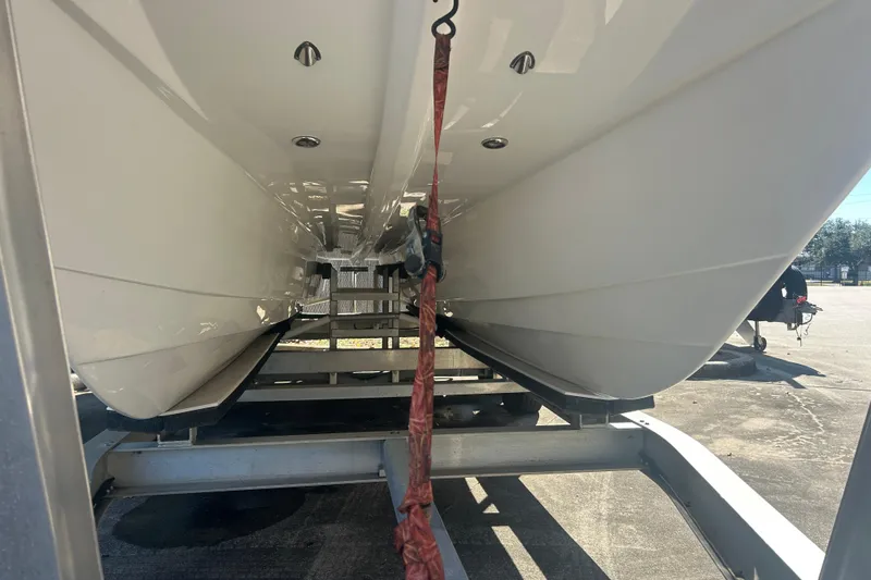 Slide: The Image of 2021 Twin Vee 260 VIVA catamaran hull on trailer, viewed from below. - 7