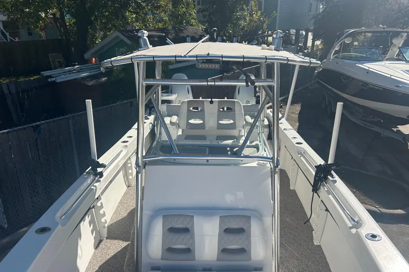 Slide: The Image of 2021 Twin Vee 260 VIVA boat with canopy and seating, docked outdoors. - 9