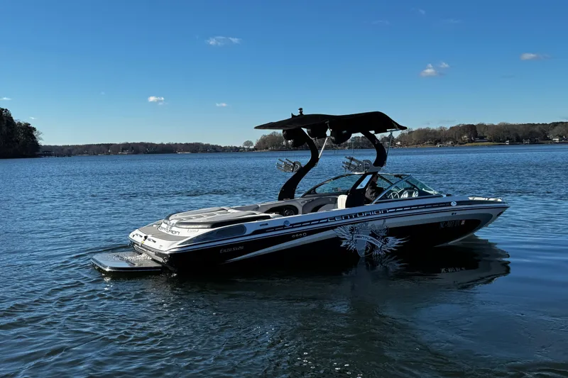 Slide: The Image of 2012 Centurion Enzo SV211 boat on a calm lake under a clear blue sky. - 12