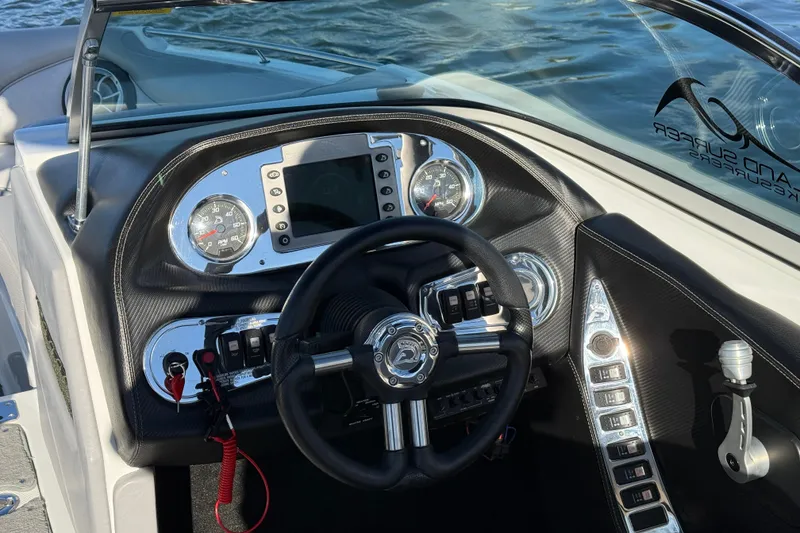 Slide: The Image of 2012 Centurion Enzo SV211 boat dashboard with steering wheel and control panel. - 14