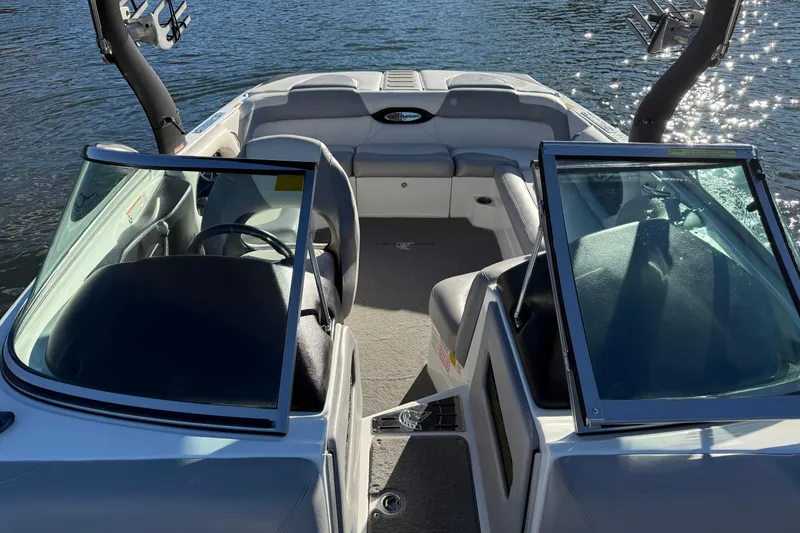 Slide: The Image of 2012 Centurion Enzo SV211 boat interior with open windshield, on calm water. - 17