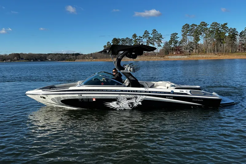 Slide: The Image of 2012 Centurion Enzo SV211 boat on a lake under a clear blue sky. - 6