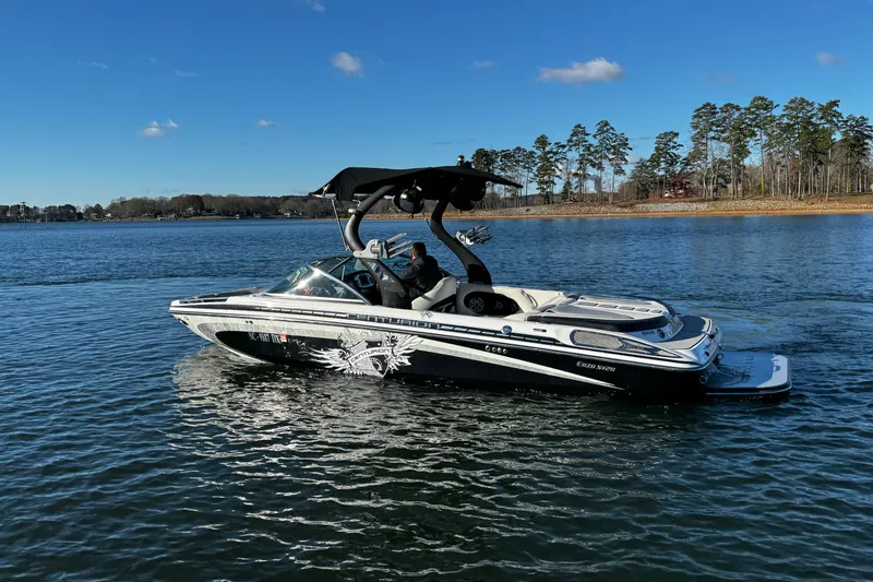 Slide: The Image of 2012 Centurion Enzo SV211 boat on a serene lake with clear blue skies. - 7