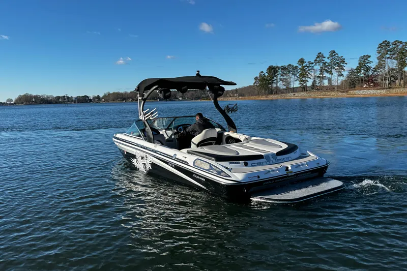 Slide: The Image of 2012 Centurion Enzo SV211 boat cruising on a clear lake under a blue sky. - 8