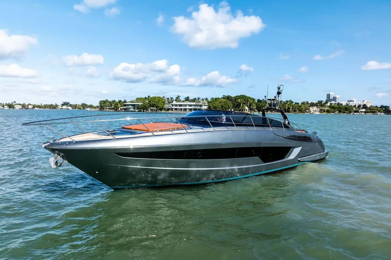 Slide: The Image of 2021 Riva 56 Rivale yacht cruising on a sunny day, surrounded by calm waters. - 8
