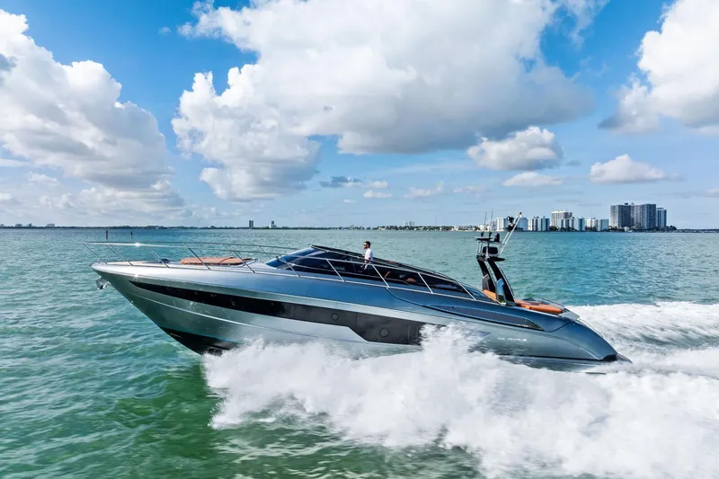 The Image of 2021 Riva 56 Rivale yacht cruising on open water under a blue sky. - 1