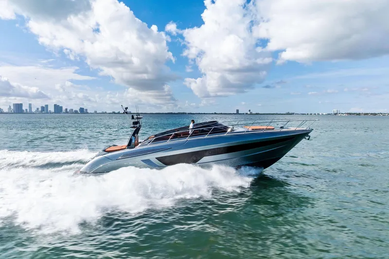 Slide: The Image of 2021 Riva 56 Rivale yacht cruising on open water under a blue sky. - 4