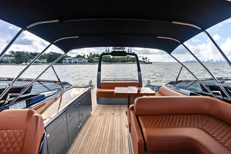 Slide: The Image of Luxurious 2021 Riva 56 Rivale yacht interior with elegant seating and scenic waterfront view. - 23