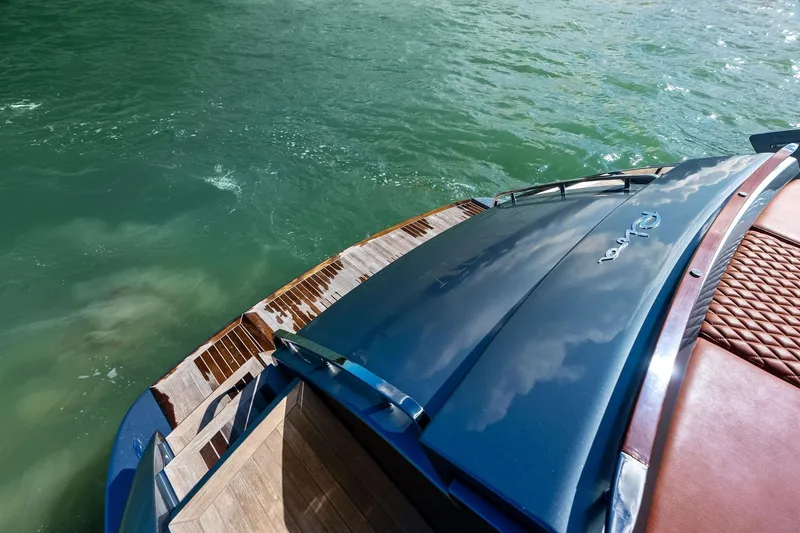 Slide: The Image of Luxury 2021 Riva 56 Rivale yacht on turquoise water, showcasing elegant design and craftsmanship. - 16