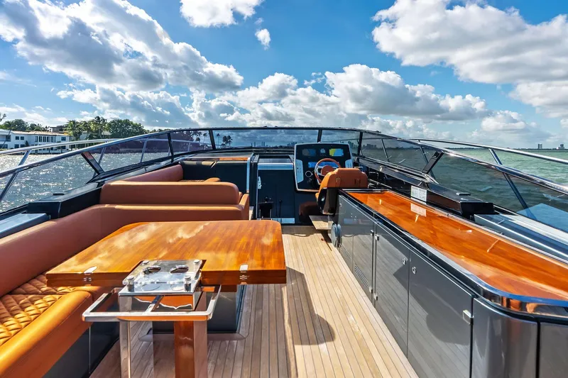 Slide: The Image of Luxurious 2021 Riva 56 Rivale yacht interior with elegant seating and wooden finishes on a sunny day. - 27