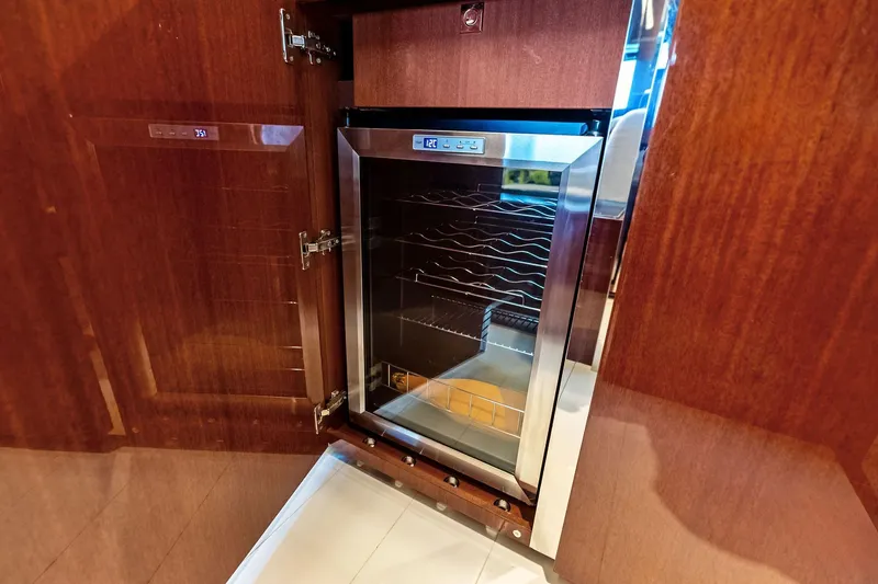 Slide: The Image of Luxury yacht Riva 56 RIVALE 2021 interior with sleek wooden cabinetry and built-in wine cooler. - 46