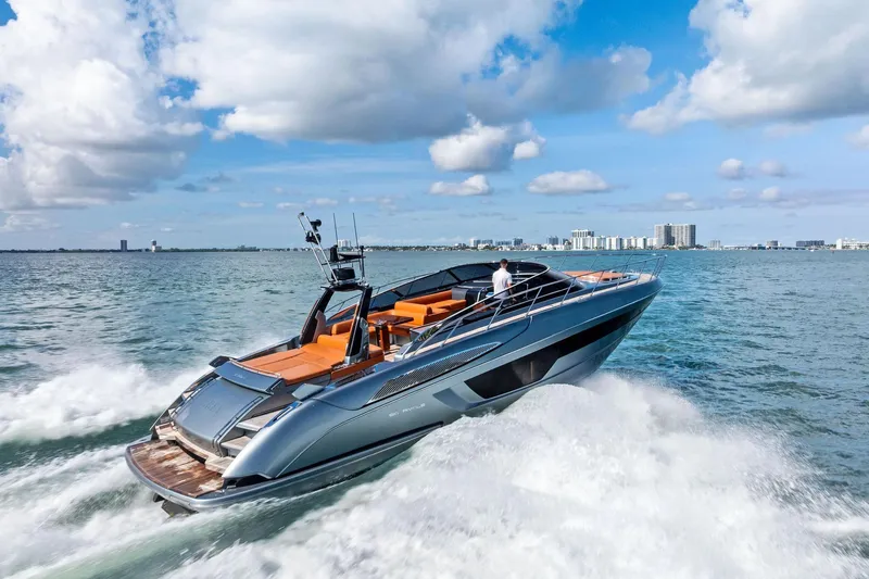 Slide: The Image of 2021 Riva 56 Rivale yacht cruising on open water under a blue sky. - 3