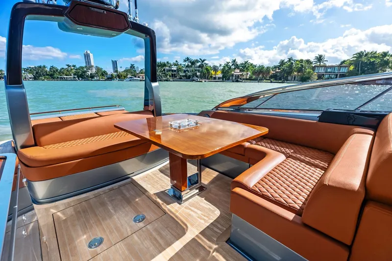 Slide: The Image of Luxurious 2021 Riva 56 Rivale yacht with elegant seating and scenic waterfront view. - 30