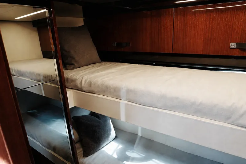 Slide: The Image of Luxurious bunk beds in 2021 Riva 56' Rivale yacht cabin, featuring sleek wood paneling. - 61