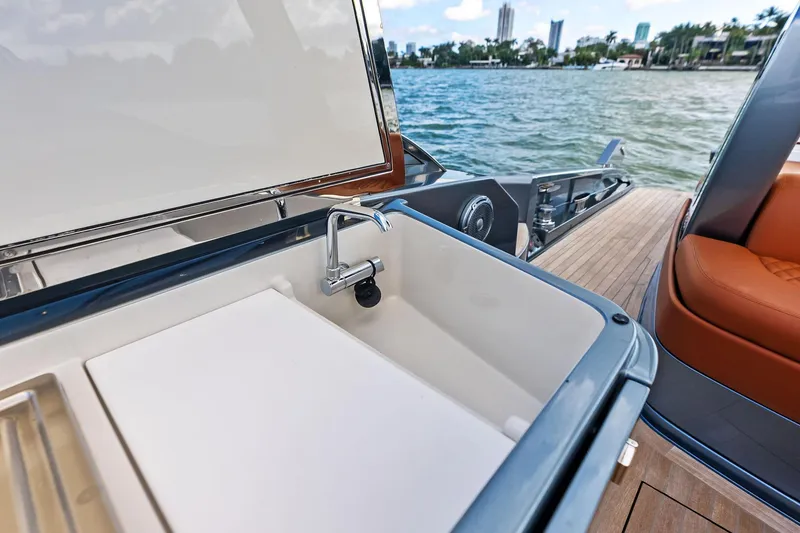 Slide: The Image of Luxury yacht Riva 56 RIVALE 2021 with onboard sink and scenic waterfront view. - 29