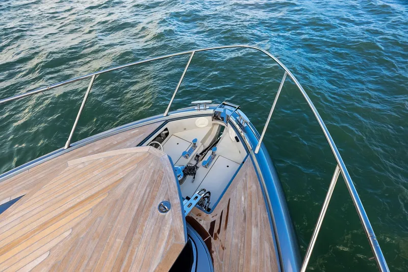 Slide: The Image of Bow view of 2021 Riva 56 Rivale yacht with teak deck on water. - 38