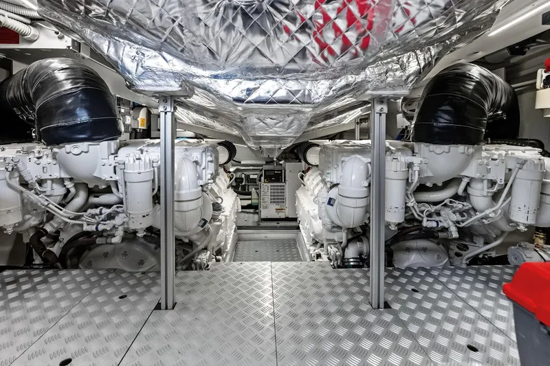 Slide: The Image of Engine room of 2021 Riva 56 RIVALE yacht, showcasing dual engines and metallic flooring. - 62