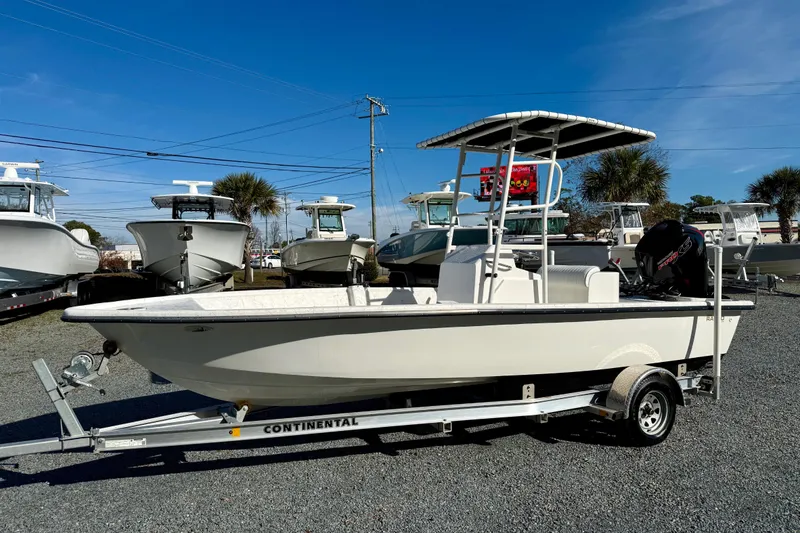 The Image of 2023 Rabco R21 boat on trailer, displayed outdoors under clear blue sky. - 1