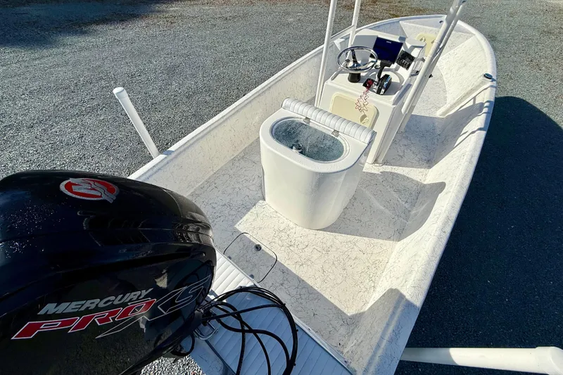 Slide: The Image of 2023 Rabco R21 boat with Mercury Pro XS engine, featuring a sleek interior design. - 14