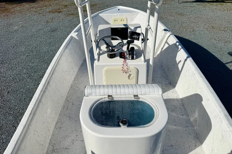 Slide: The Image of 2023 Rabco R21 boat interior with steering console and seating. - 16