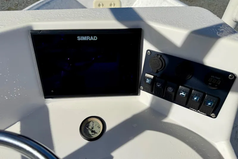 Slide: The Image of Control panel of 2023 Rabco R21 boat with Simrad display and switches. - 18
