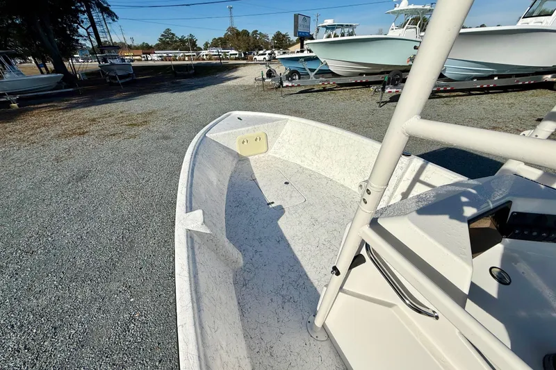 Slide: The Image of 2023 Rabco R21 boat on display at a dealership, surrounded by other boats. - 20
