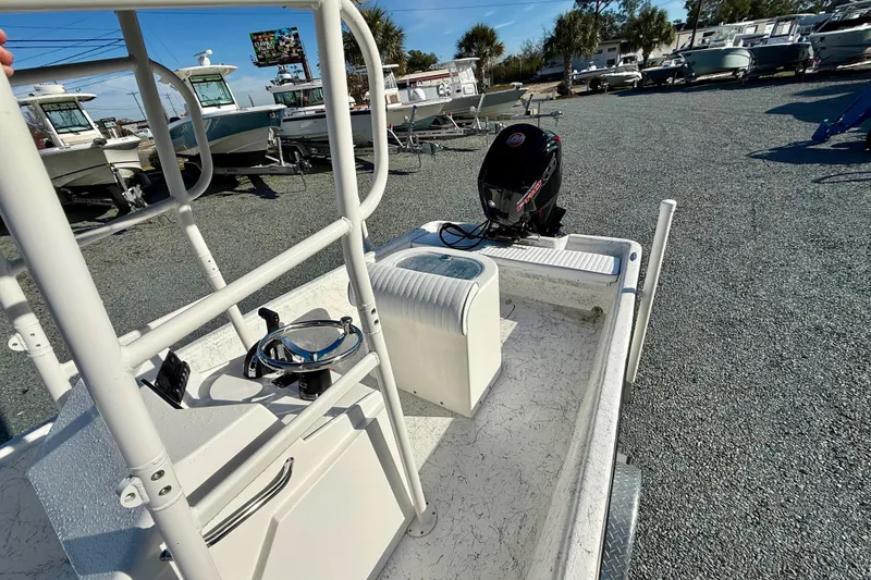 Slide: The Image of 2023 Rabco R21 boat with motor, parked in a marina with other boats. - 23