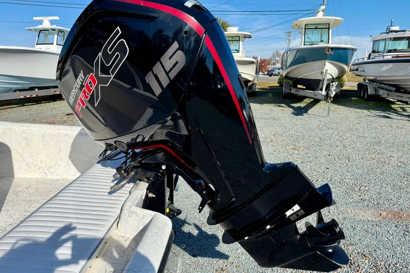 Slide: The Image of Rabco R21 boat with Mercury Pro XS outboard motor, 2023 model, in a marina setting. - 4