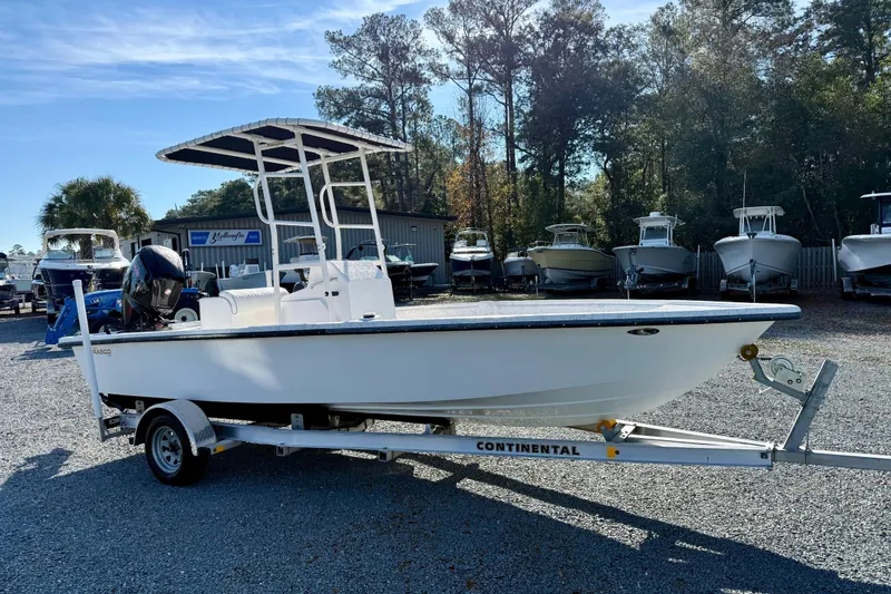 Slide: The Image of 2023 Rabco R21 boat on trailer, parked outdoors with other boats in background. - 8