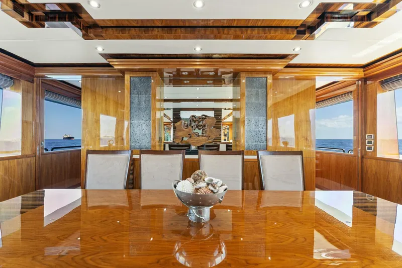 Slide: The Image of Luxurious dining area on 2013 Hargrave 125 Raised Pilothouse yacht with elegant wood finishes. - 11