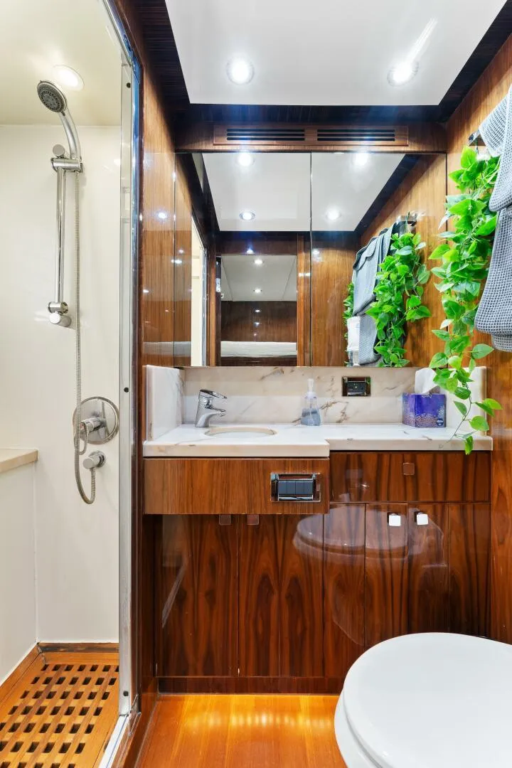 Slide: The Image of Luxurious bathroom in 2013 Hargrave 125 Raised Pilothouse yacht with wood accents and modern fixtures. - 24