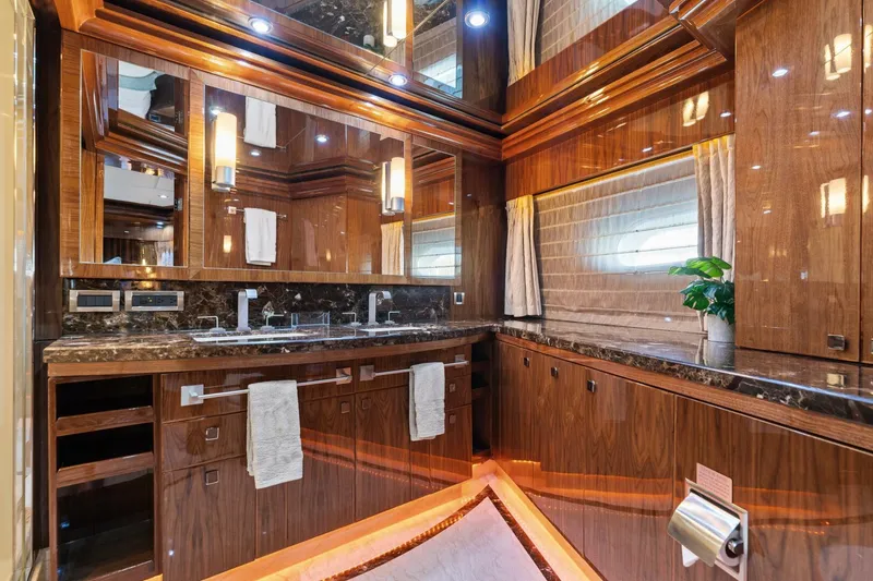 Slide: The Image of Luxurious bathroom in 2013 Hargrave 125 Raised Pilothouse yacht with wood finishes and marble countertops. - 26