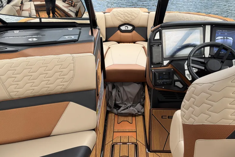 Slide: The Image of Interior of 2025 Centurion Ri265 boat with luxurious seating and advanced dashboard controls. - 15