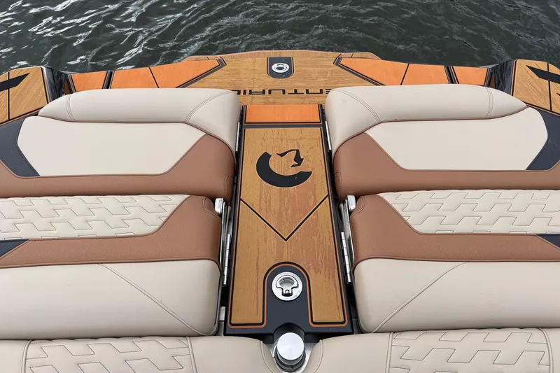 Slide: The Image of 2025 Centurion Ri265 boat interior with tan and brown seating on water. - 17