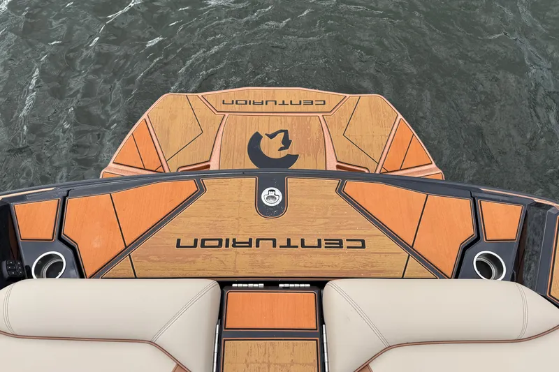 Slide: The Image of 2025 Centurion Ri265 boat deck with stylish wood finish on water. - 19