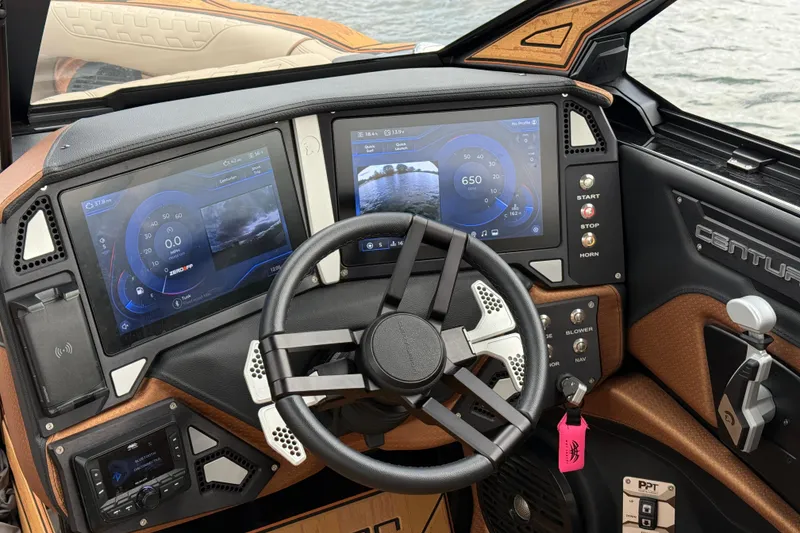 Slide: The Image of Dashboard of 2025 Centurion Ri265 boat with dual touchscreens and modern controls. - 20