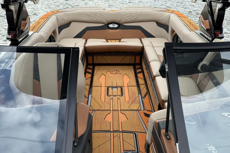 Slide: The Image of 2025 Centurion Ri265 boat interior with luxurious seating and stylish design on the water. - 24