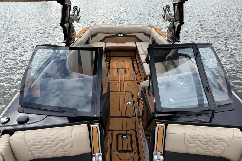 Slide: The Image of 2025 Centurion Ri265 boat interior with luxurious seating and sleek design on the water. - 25