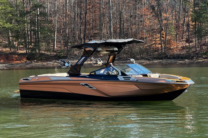 Slide: The Image of 2025 Centurion Ri265 boat on a serene lake with forest backdrop. - 3