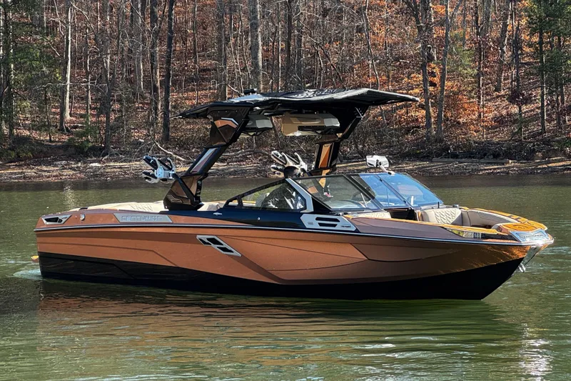 Slide: The Image of 2025 Centurion Ri265 boat on a calm lake with autumn forest backdrop. - 4