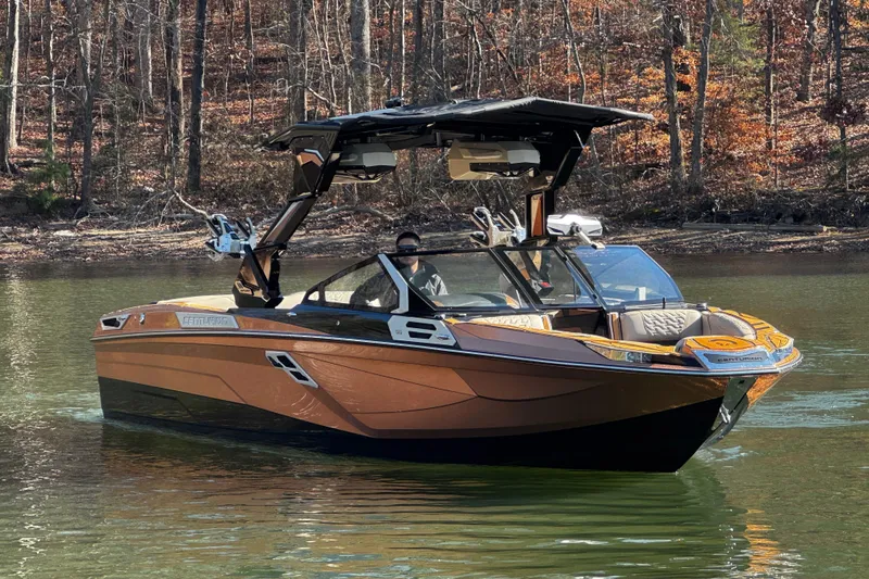 Slide: The Image of 2025 Centurion Ri265 boat on a calm lake with autumn trees in the background. - 5