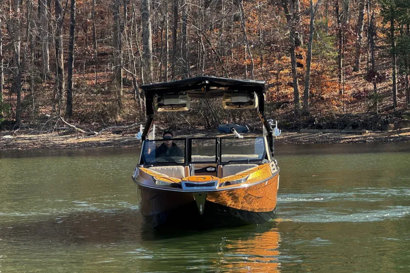 Slide: The Image of 2025 Centurion Ri265 boat on a calm lake with autumn forest backdrop. - 6