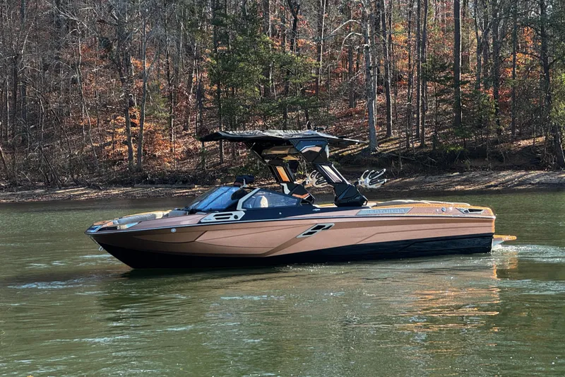 Slide: The Image of 2025 Centurion Ri265 boat on a serene lake with autumn forest backdrop. - 8